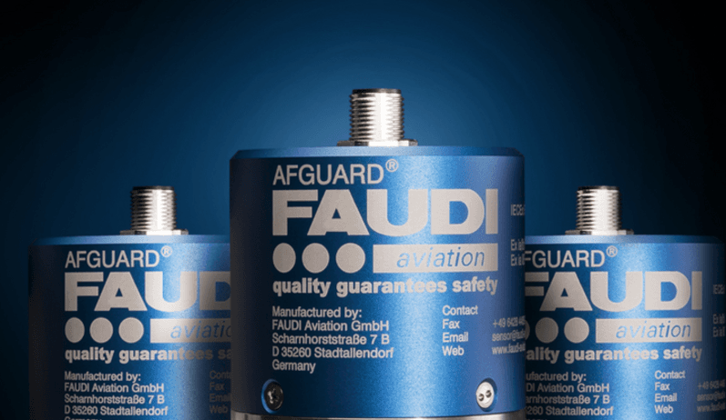 Close-up of three FAUDI Aviation AFGUARD filter sensors, cylindrical and metallic blue, with silver screw connectors on top, set against a dark blue gradient background